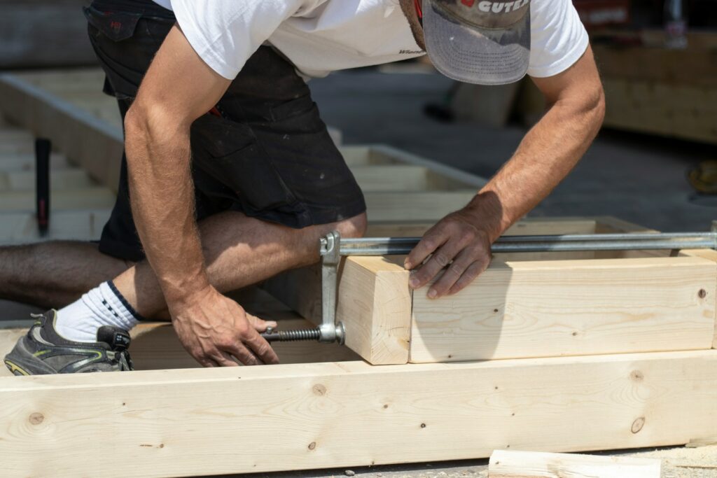 man holding gray metal hand tool